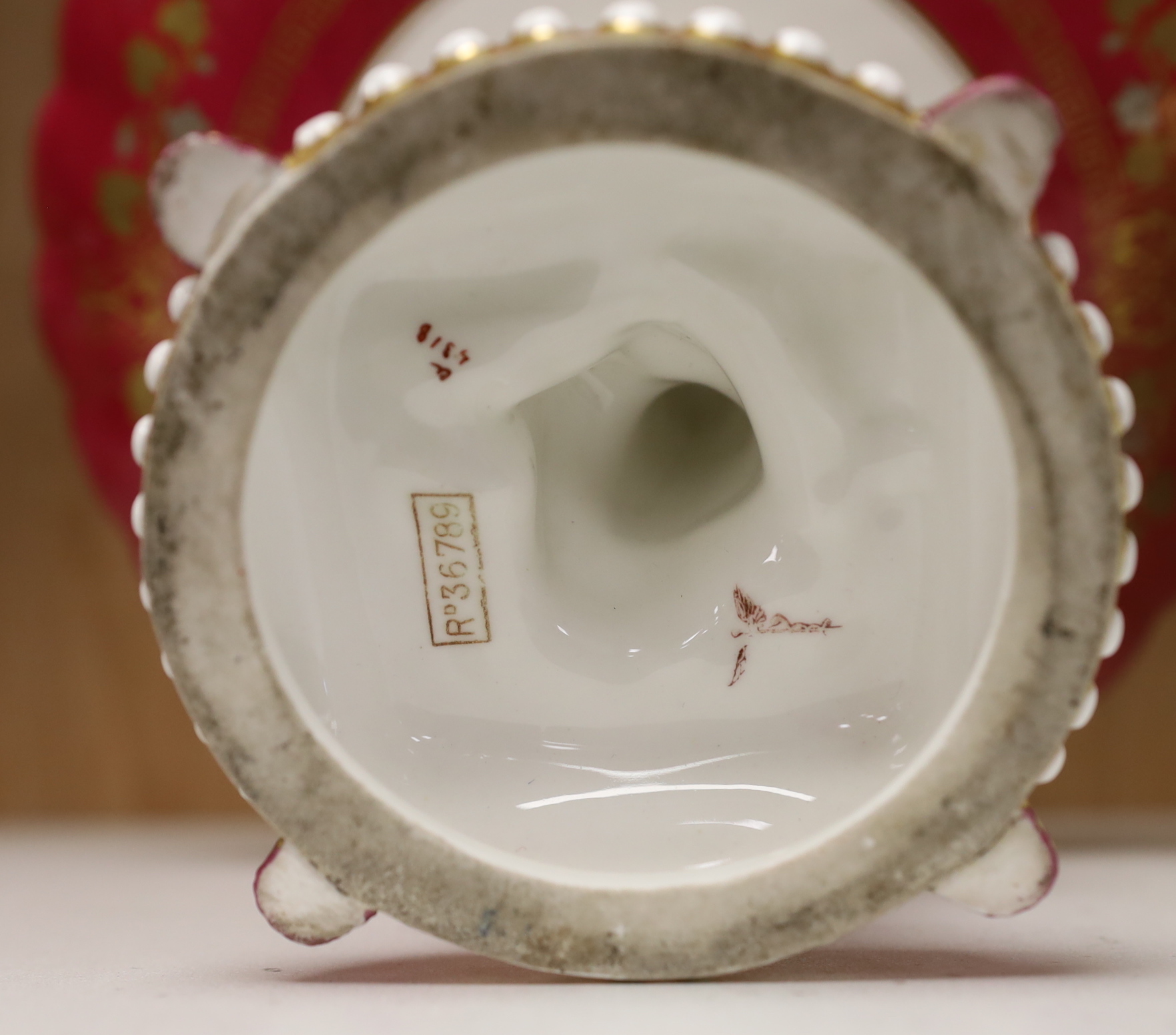 A pair of Royal Worcester figural sugar casters, a pot pourri and a Staffordshire putti comport, the largest 23.5cm in diameter